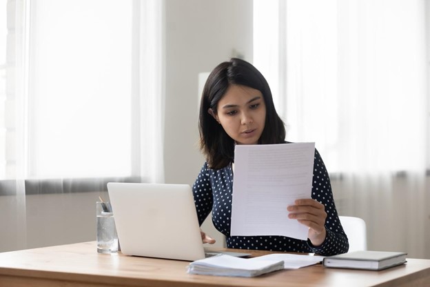 Young woman writing an offer letter before making an offer on a home