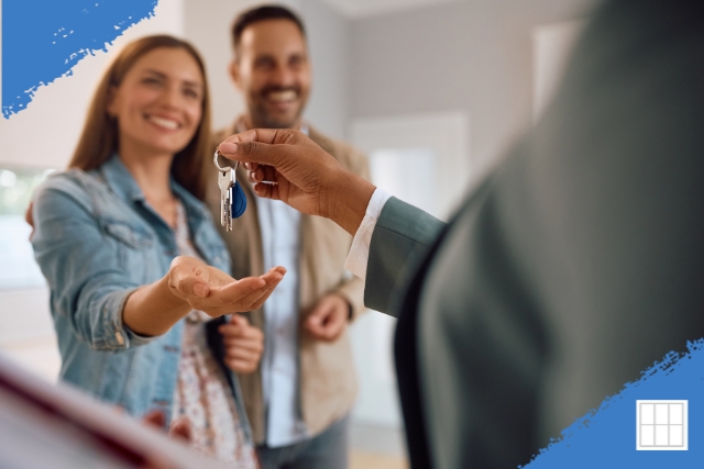 Happy couple receiving house keys after successfully buying before selling their home in Kansas City using a bridge strategy