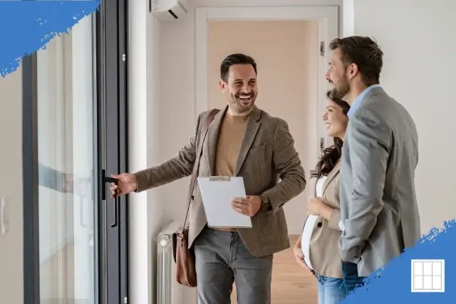 Smiling mortgage broker or lender in Overland Park showing a couple their new home, highlighting local home loans.
